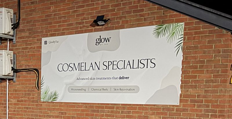 The Glow By Yaz sign on the brick wall outside the clinic at 21 Wharfside, Fenny Stratford, Bletchley, in the evening