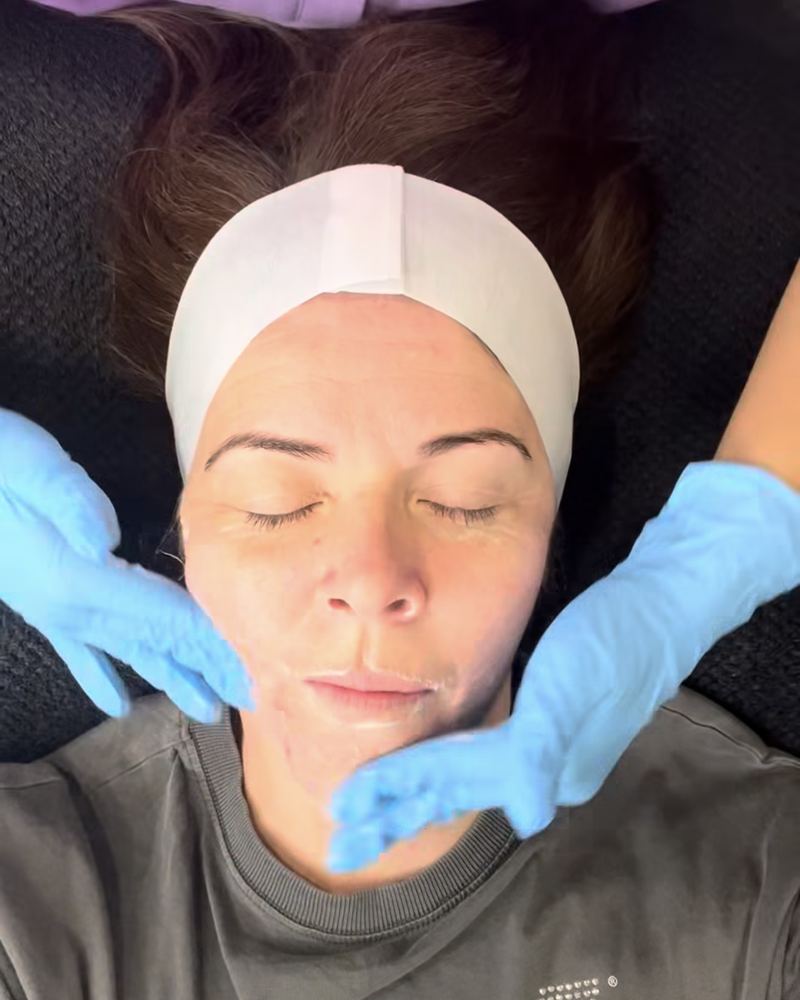 A client relaxing on the treatment couch at Glow By Yaz after a facial