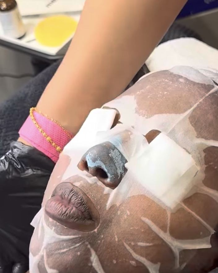 A client wearing a face mask and eye pads during a facial in the treatment room at Glow By Yaz, Bletchley