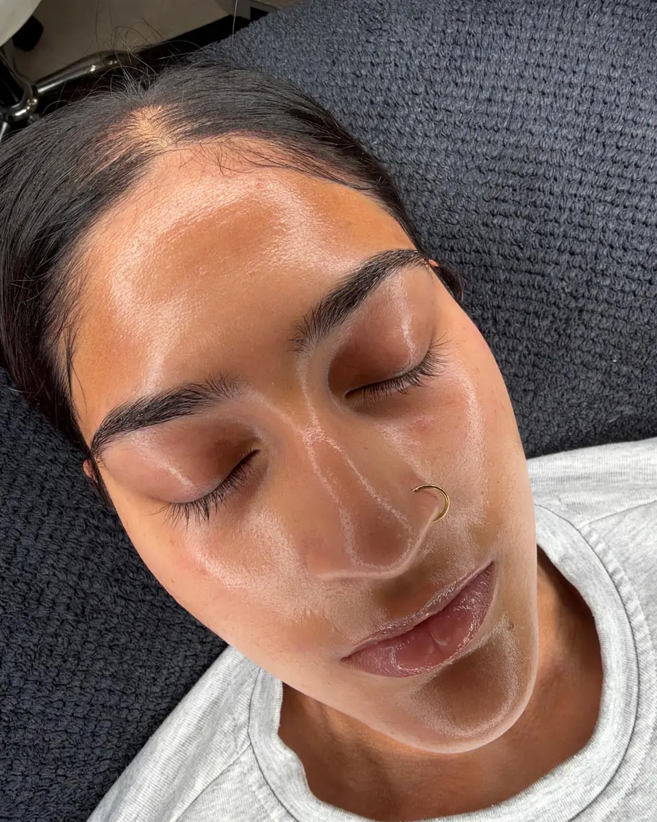 A client resting with her eyes closed on the treatment couch at Glow By Yaz after an in-clinic facial